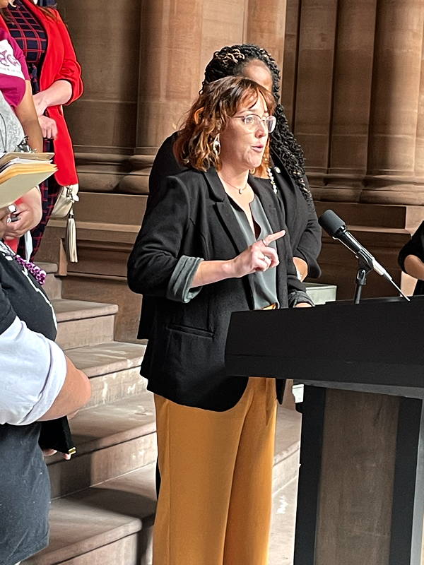 DSW Staff Attorney Becca Cleary addresses the press in Albany during a lobby day advocating for Immunity in 2023.