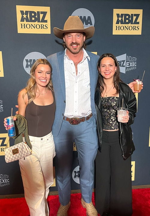 DSW Executive Assistant Maddy Kammeraad-Campbell and Development Manager Esme Bengtson with content creator Coal Daniels at the XBIZ Honors ceremony in LA.