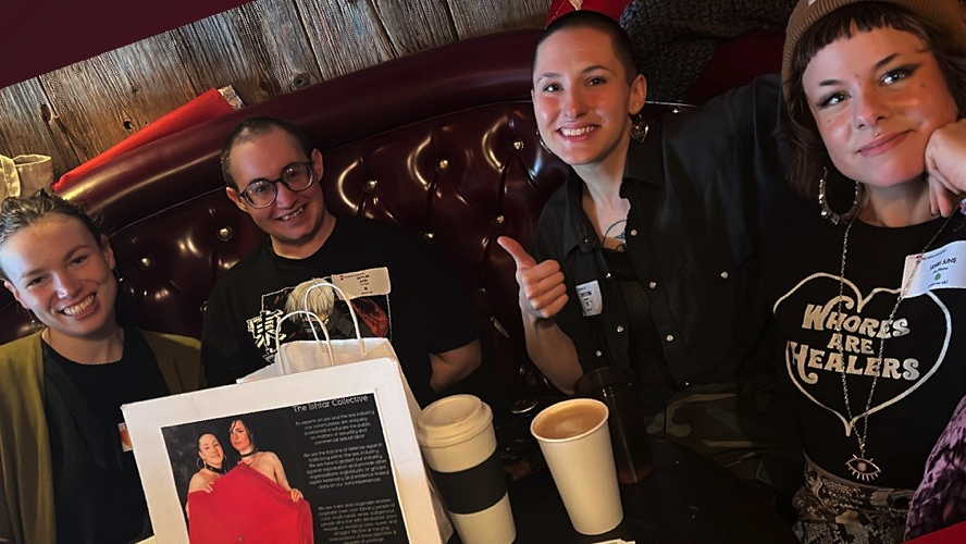 Emma R., Skylar Axel, Christine R., and Henri Bynx pose for a photo at Muddy Waters Cafe in Burlington, Vermont.