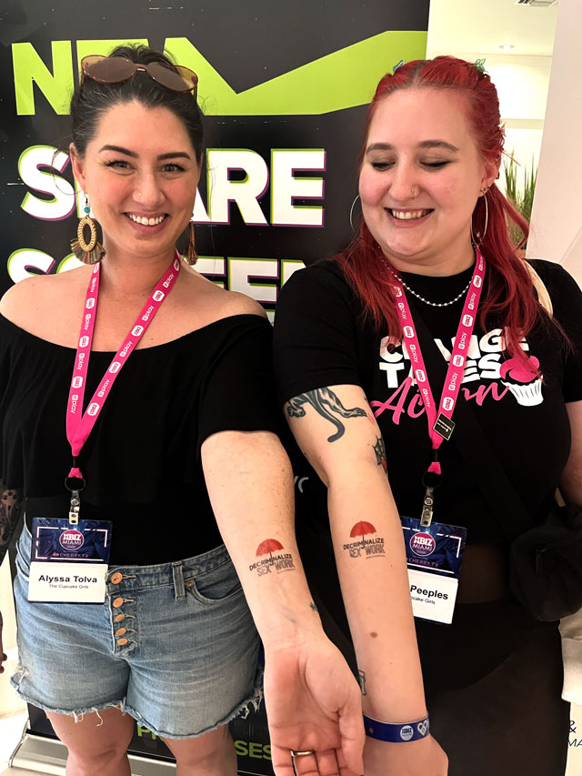 Members of The Cupcake Girls display their “Decrim Sex Work” temporary tattoos.