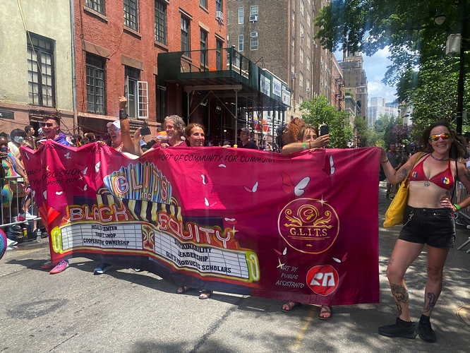 DSW and G.L.I.T.S. Inc. staffers carry the G.L.I.T.S. banner through Greenwich Village towards the end of the march (DSW 2021)
