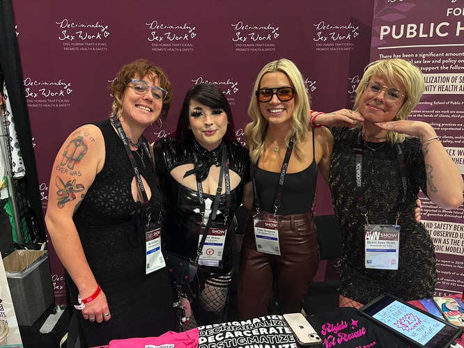 DSW Staff Attorney Rebecca Cleary, content creator and advocate @onlypomma, DSW Development Manager Esmé Bengtson and DSW Community Engagement Consultant Henri Bynx pose in front of the DSW booth at AVN.